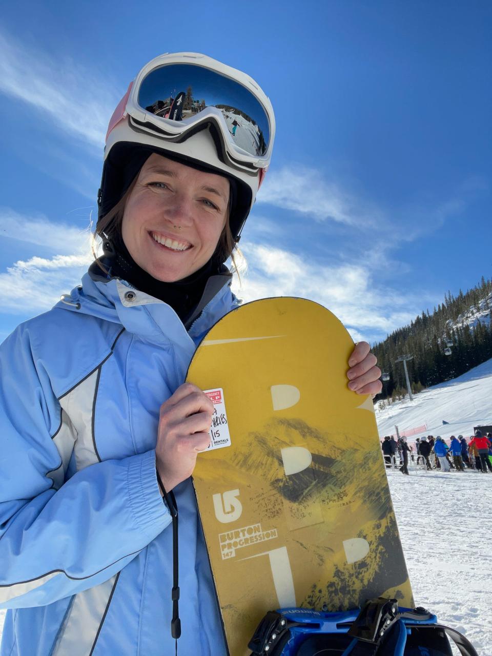The author holds a rented snowboard in Winter Park, Colorado.