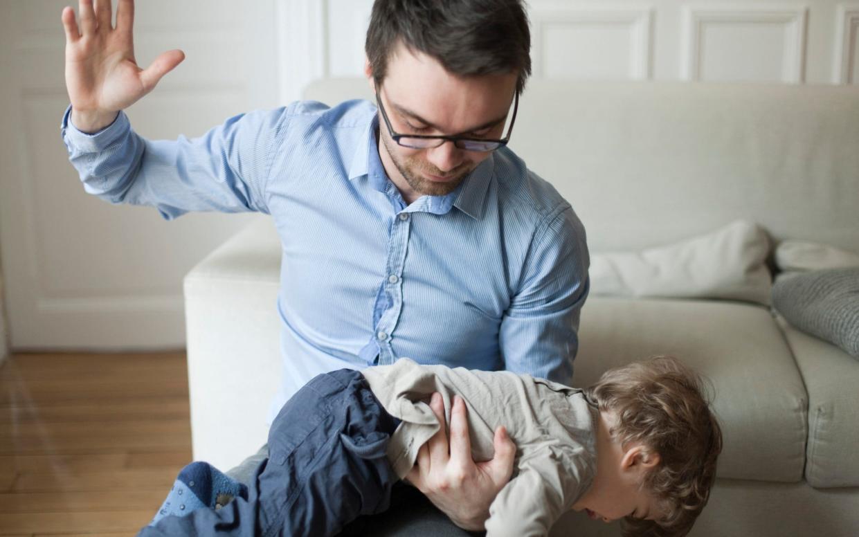 Father disciplining toddler