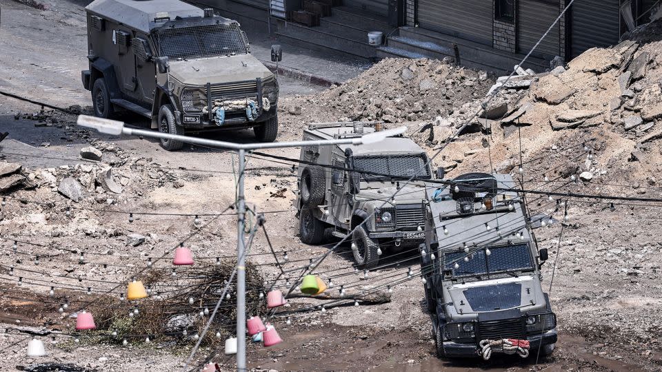 Israeli army armoured vehicles move along an excavated section of a road in the centre of Jenin in the occupied West Bank on Thursday amid ongoing military operations in the Palestinian territories. - Zain Jaafar/AFP/Getty Images