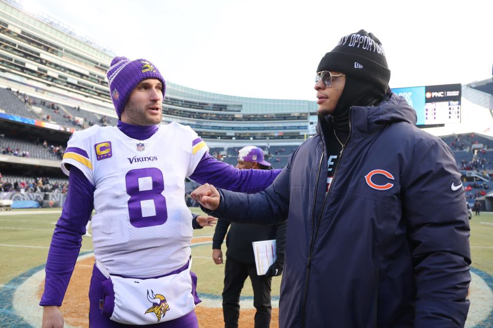 CHICAGO, ILLINOIS - JANUARY 08: Kirk Cousins #8 of the Minnesota Vikings talks with Justin Fields #1 of the Chicago Bears after the game at Soldier Field on January 08, 2023 in Chicago, Illinois. (Photo by Michael Reaves/Getty Images)