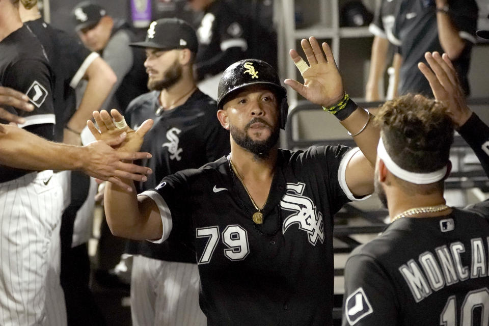 Chicago White Sox's Jose Abreu is greeted in the dugout after he scored on a bases loaded walk by Pittsburgh Pirates relief pitcher Chasen Shreve during the sixth inning of a baseball game Tuesday, Aug. 31, 2021, in Chicago. (AP Photo/Charles Rex Arbogast)