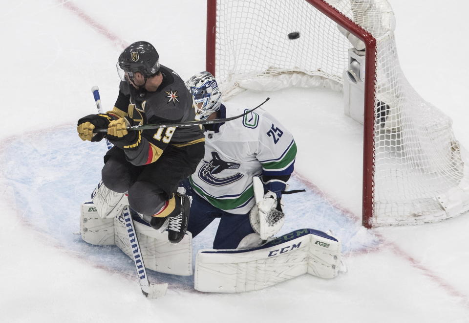 Vegas Golden Knights' Reilly Smith (19) jumps as the puck goes past Vancouver Canucks goalie Jacob Markstrom (25) during the third period of Game 2 of an NHL hockey second-round playoff series, Tuesday, Aug. 25, 2020, in Edmonton, Alberta. (Jason Franson/The Canadian Press via AP)