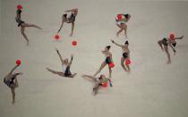 <p>In this photo taken with multiple exposures, Germany’s Jana Berezko-Marggrander performs in the rhythmic gymnastics individual all-around qualifications during the Summer Olympics in Rio de Janeiro, Brazil, Friday, Aug. 19, 2016. (AP Photo/Julio Cortez) </p>
