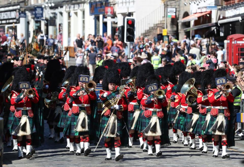 The Band of the Royal Regiment of Scotland march along the Royal Mile in Edinburgh following the Order of the Thistle Service at St Giles' Cathedral.