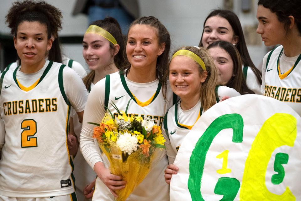 Lansdale Catholic senior Gabby Casey poses for photos with her teammates after becoming the school's all-time leading scorer in girls basketball during their game against Bonner and Prendergast Catholic at Lansdale Catholic High School on Tuesday, Jan. 10, 2023.