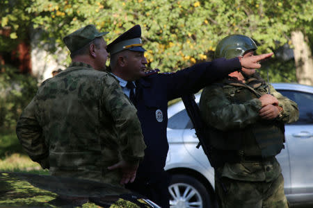 Law enforcement officers gather at the scene of a fatal attack on a college in the port city of Kerch, Crimea October 17, 2018. Ekaterina Kejzo/Courtesy of Kerch.FM/Handout via REUTERS