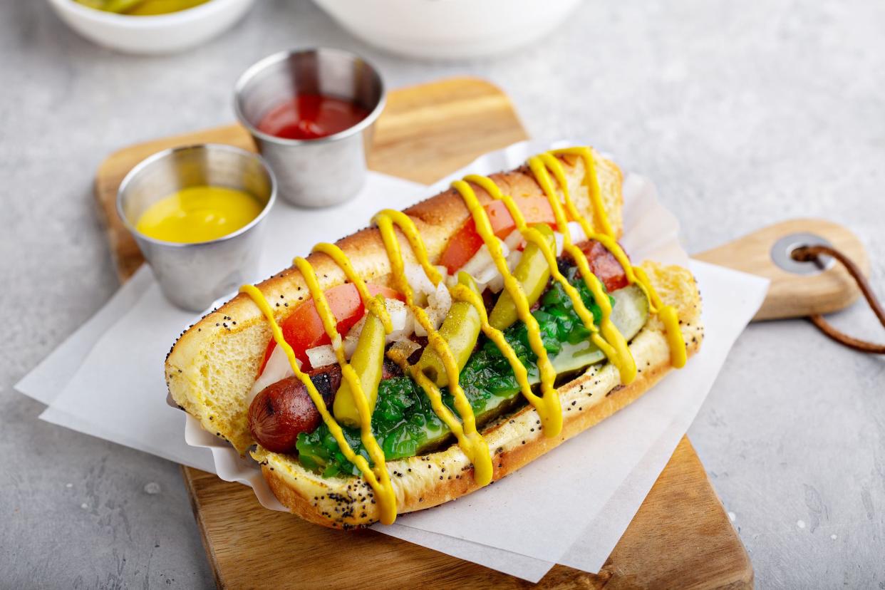 Chicago hot dog on a poppy seed bun topped with tomatoes and sweet relish