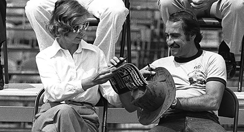 FILE - In this May 28, 1977 file photo, Janet Guthrie (left) interacts with Bill Vukovich Jr. during a drivers meeting for the 61st Indianapolis 500 at Indianapolis Motor Speedway.