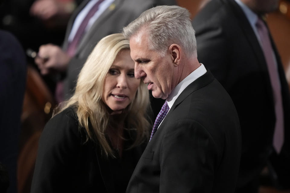 Rep. Marjorie Taylor Greene, R-Ga., and Rep. Kevin McCarthy, R-Calif., look at vote totals during the roll call vote on the motion to adjourn for the evening in the House chamber as the House meets for a second day to elect a speaker and convene the 118th Congress in Washington, Wednesday, Jan. 4, 2023. (AP Photo/Andrew Harnik)