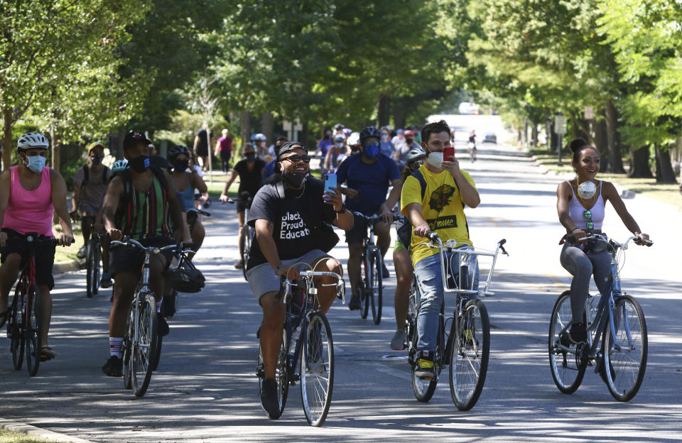 FILE - Otis Campbell, center left, leads a group of bicyclists to Tower Road Beach on Sept. 5, 2020, in Winnetka, Ill. A white woman charged with a hate crime following a confrontation where she told a group of Black men in 2020 that they couldn't be at a suburban Chicago beach has been sentenced to probation after pleading guilty to a lesser charge. The felony hate crime charge Irene Donoshaytis had faced in Cook County was amended Wednesday, Oct. 19, 2022, to a misdemeanor battery under a plea agreement. (John J. Kim/Chicago Tribune via AP, File)