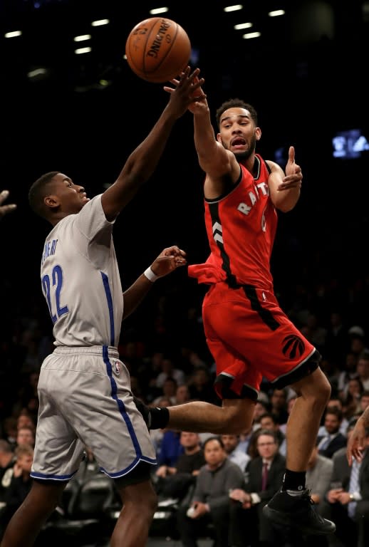 Cory Joseph (R) of the Toronto Raptors passes the ball as Caris LeVert of the Brooklyn Nets defends, at the Barclays Center in New York, on January 17, 2017