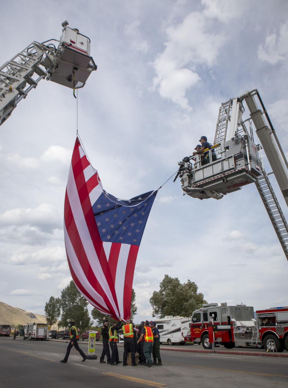 The Jackson Hole Fire Department raises a flag for the procession for Marine Lance Cpl. Rylee McCollum in Jackson, Wyo., Friday, Sept. 10, 2021. McCollum was one of the service members killed in Afghanistan after a suicide bomber attacked Hamid Karzai International Airport on Aug. 26. (AP Photo/Amber Baesler)