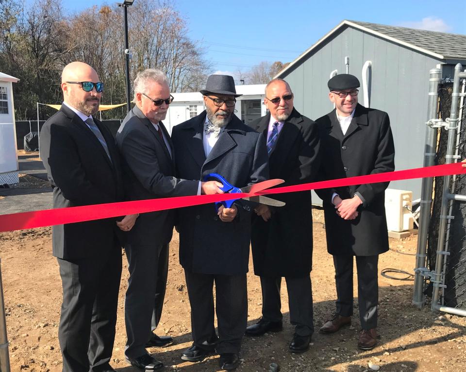 The Village of Hope is not yet occupied, but Thursday was opening day for the pilot community of "tiny home" intended for newly released prison inmates. L-R: Paul Taggines, chief operating officer, The Kintock Group; Kevin McHugh, executive director, Reentry Coalition of New Jersey; Bridgeton Mayor Albert Kelly; state Sen. Edward Durr, R-3; and the Rev. Robin Weinstein, Bethany Grace Community Church. The six manufactured homes are at 5 West Industrial Boulevard in Bridgeton. Photo/Nov. 17, 2022