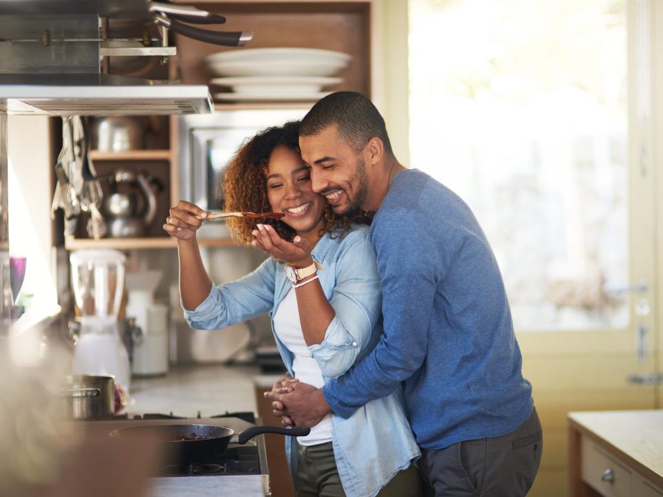 A couple cooking together.