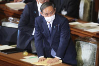 Japanese Prime Minister Yoshihide Suga attends an extraordinary Diet session to deliver his policy speech at the upper house of parliament in Tokyo, Monday, Oct. 26, 2020. Suga has declared Japan will achieve zero carbon emissions by 2050 in his first policy speech after taking over from Shinzo Abe. The policy speech Monday at the outset of the parliamentary session set an ambitious agenda reflecting Suga's pragmatic approach to getting things done. (AP Photo/Koji Sasahara)