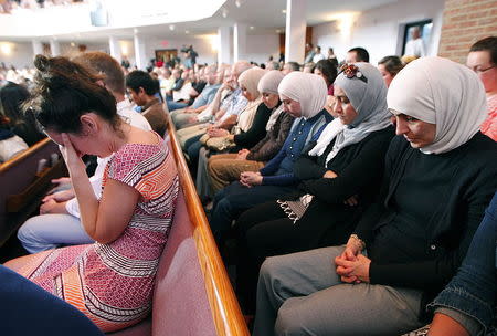 People, from different faiths, pray during an interfaith vigil for the victims of the Tennessee shooting, at Olivet Baptist church in Chattanooga, Tennessee, July 17, 2015. REUTERS/Tami Chappell