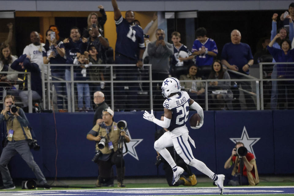 Dallas Cowboys cornerback DaRon Bland (26) returns an interception for a touchdown during the second half of an NFL football game against the Washington Commanders Thursday, Nov. 23, 2023, in Arlington, Texas. (AP Photo/Michael Ainsworth)