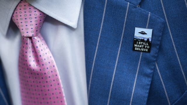 An audience member wears a UFO pin during a House Oversight and Accountability hearing.