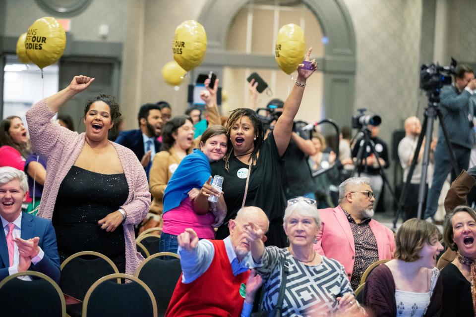 People react to television reporting during a Protect Kentucky Access election watch party in Louisville on Nov. 8, 2022.