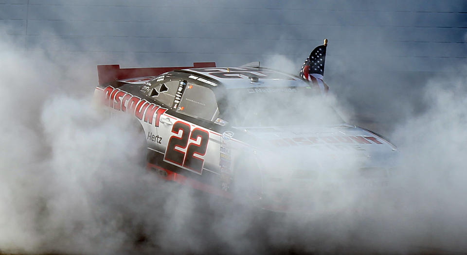 Brad Keselowski does a burnout after winning the NASCAR Nationwide Series auto race Saturday, March 8, 2014, in Las Vegas. (AP Photo/Isaac Brekken)