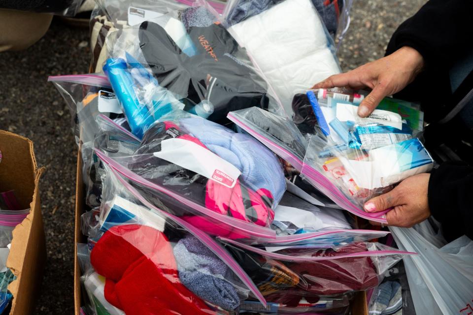 A homeless person looks through hygiene kits from Be a Little Too Kind in Salt Lake City on Thursday, Feb. 1, 2024. Be a Little Too Kind is a nonprofit organization focused on assisting homeless people by providing a homemade meal every week and other essential life sustaining items. | Megan Nielsen, Deseret News