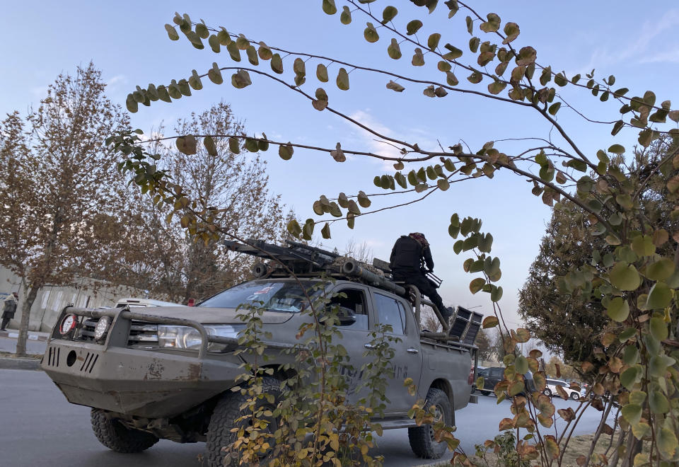 Taliban fighters stand guard near to the site of attack in Kabul, Afghanistan, Friday, Dec. 2, 2022. A prominent politician and warlord, Gulbuddin Hekmatyar, also escaped unhurt in a separate attack in Kabul on Friday, his office said in a statement. Security guards killed the two attackers as they tried to enter a mosque where Hekmatyar and his supporters had gathered for Friday prayers, the statement said. (AP Photo/Sidiqullah Khan)