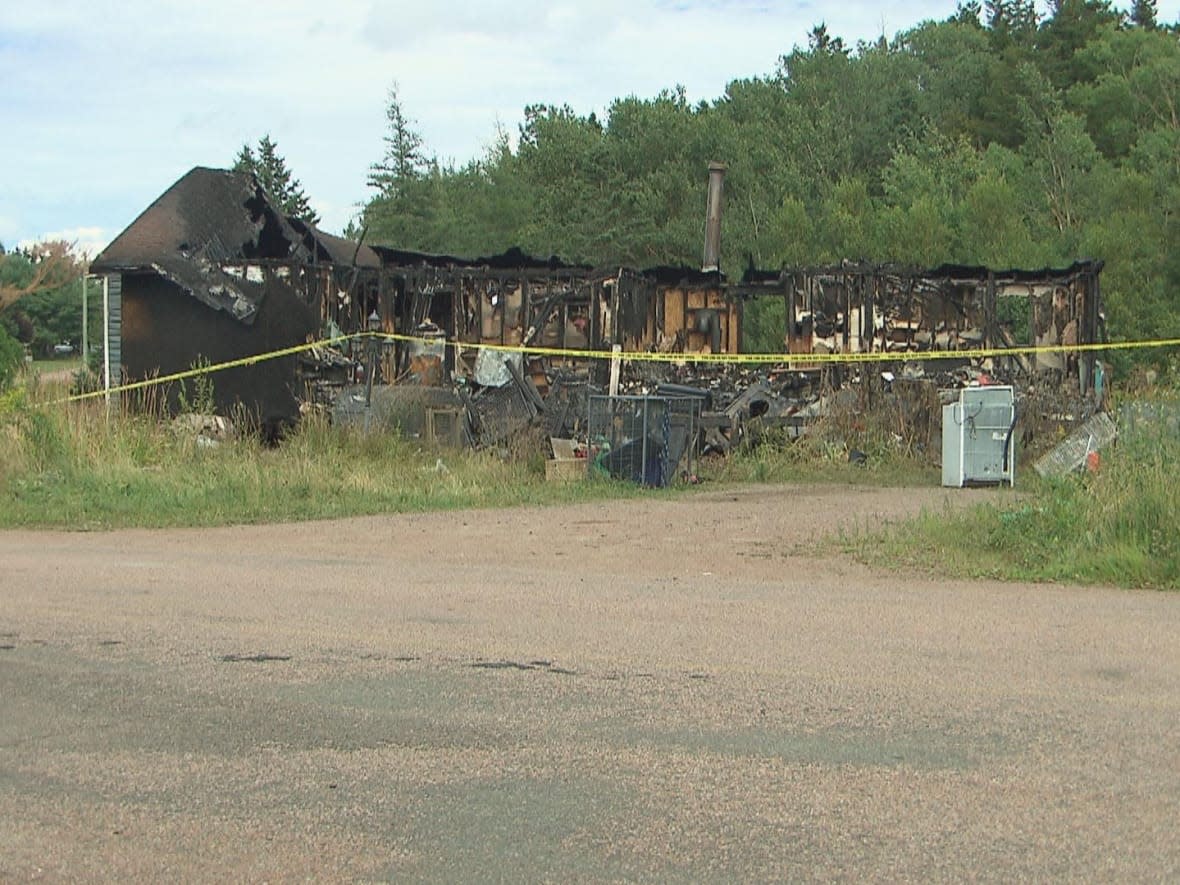 Cpl. Brian Villers says a house that caught fire in Midgic, N.B., is a 'complete loss.' (Ian Bonnell/CBC - image credit)