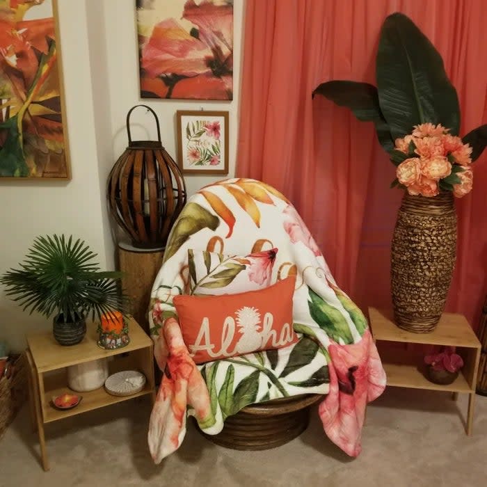 Reviewer's photo of the two side tables used separately on either side of an armchair in a tropical-themed room