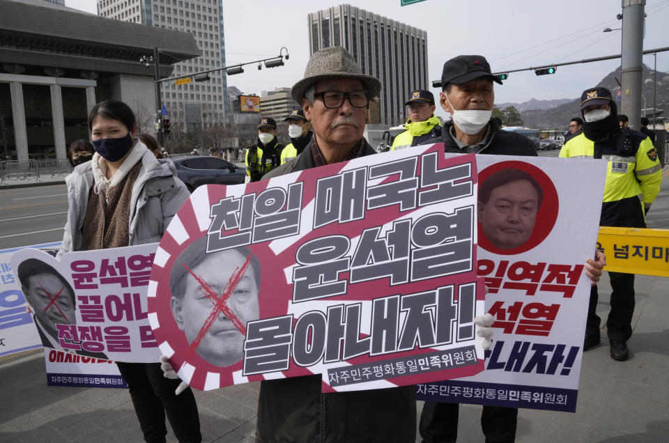 Protesters gather for a rally to oppose the visit of South Korean President Yoon Suk Yeol to Japan, in front of the U.S. embassy in Seoul, South Korea, Thursday, March 16, 2023. South Korean and Japanese leaders will meet later Thursday in Tokyo in a bid to overcome disputes over history and quickly rebuild security and economic ties later, as a North Korean missile launch and encounters between Japanese and Chinese vessels in disputed waters show what's at stake for the two countries. The signs read "A pro-Japanese traitor." (AP Photo/Ahn Young-joon)