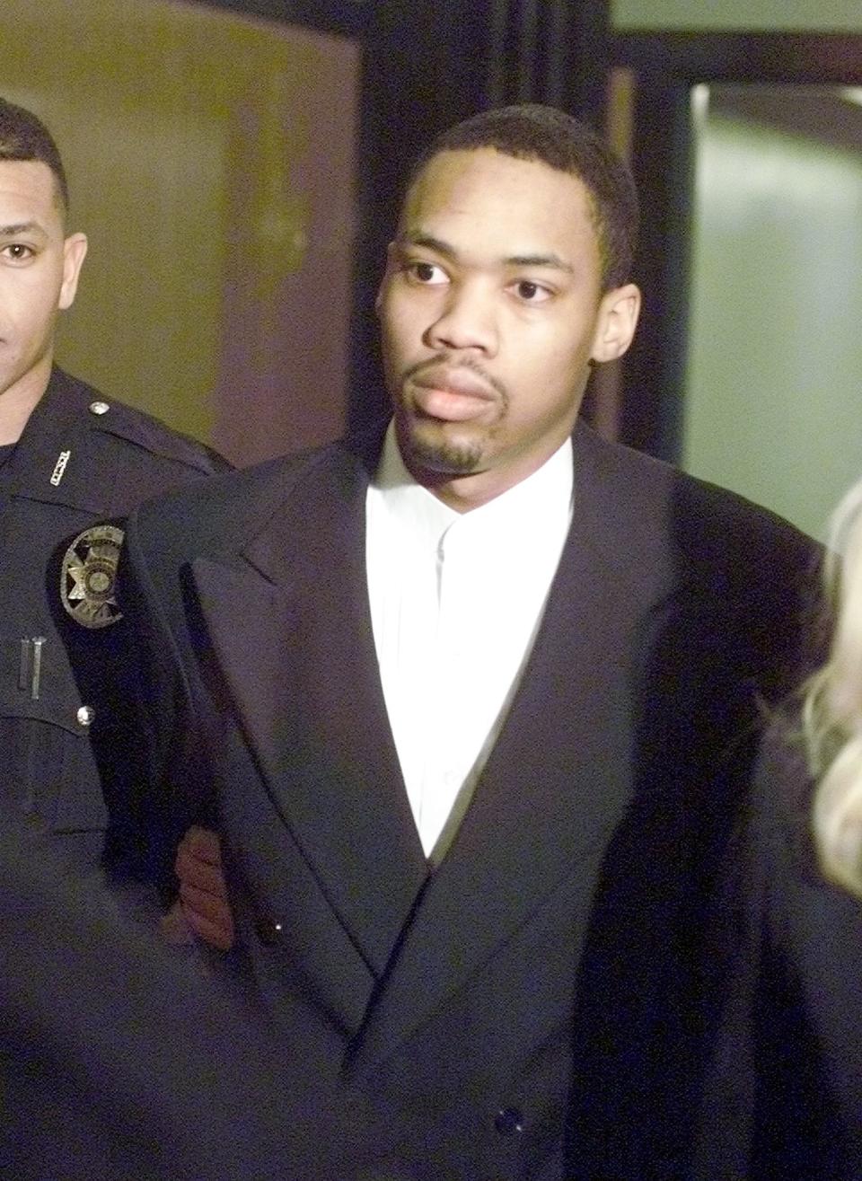 In this 2002 photo, convicted murderer Julius Jones leaves an Oklahoma County courtroom in handcuffs after receiving the death penalty.