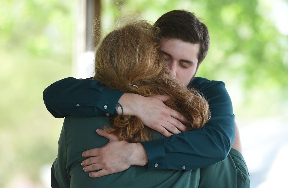 Jessica Hiatt's mother Sara Spangler and brother Ian Hiatt console each other during her celebration of life service Monday, May 16, 2022, in Slater, Iowa.