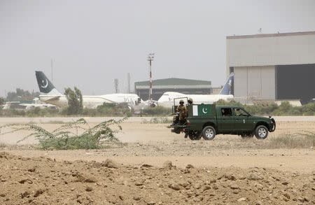 Pakistan Army soldiers patrol on a vehicle in the premises of Jinnah International Airport, after a gunfire attack on a security academy run by the Airports Security Force (ASF) in Karachi June 10, 2014. REUTERS/Stringer