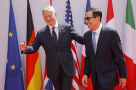 French Finance Minister Bruno Le Maire, left, welcomes Treasury Secretary Steve Mnuchin at the G-7 Finance Wednesday July 17, 2019 in Chantilly, north of Paris. The Group of Seven rich democracies' top finance officials gathered Wednesday at a chateau near Paris in search of common ground on the threats posed by digital currencies. (AP Photo/Michel Euler)