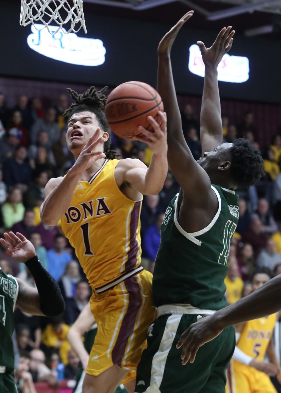 Iona's Walter Clayton Jr. drives on Manhattan's Adam Cisse during their game at Iona Feb. 17, 2023.