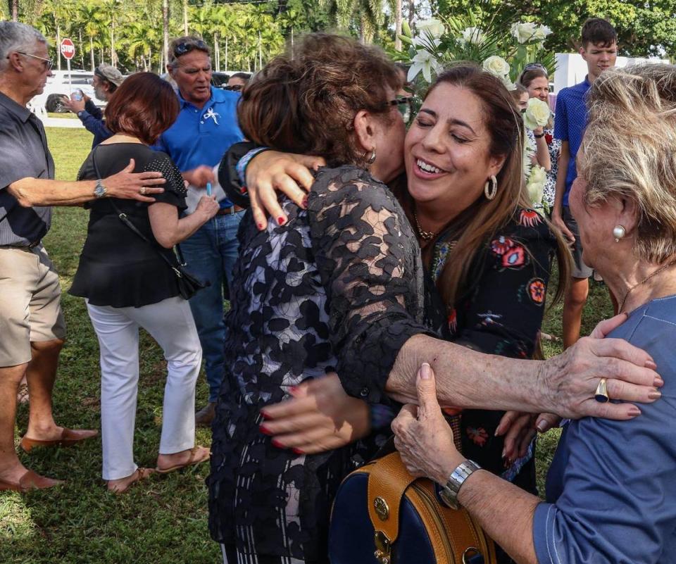 La asistente de vuelo Mercy Ruiz, a la izquierda, es abrazada por Christina Casado, de 50 años, sobreviviente del accidente, quien era una bebé cuando el avión se estrelló.