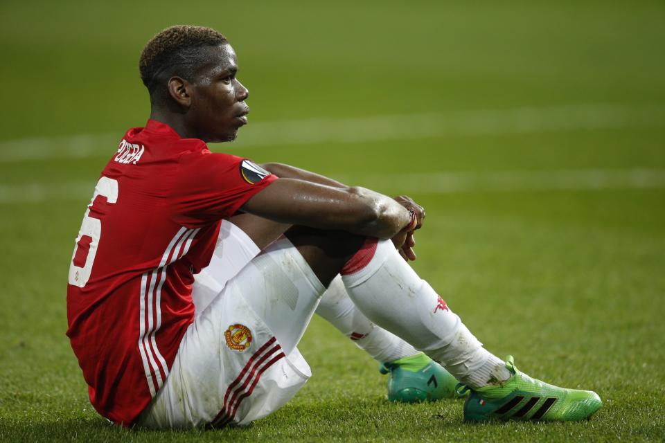 Paul Pogba sits frustrated on the pitch