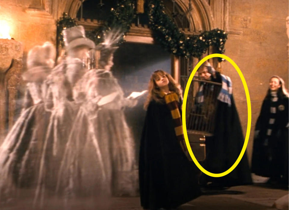 Derek in a coat and scarf circled in a scene from The Philosopher's Stone