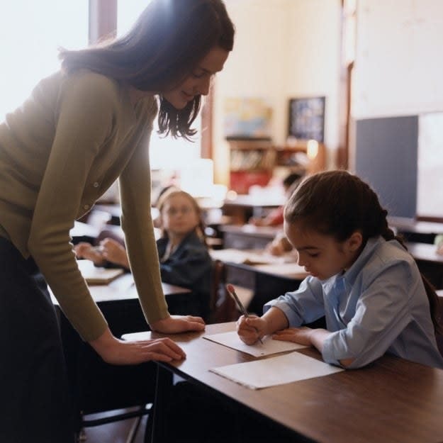 teacher helping a student