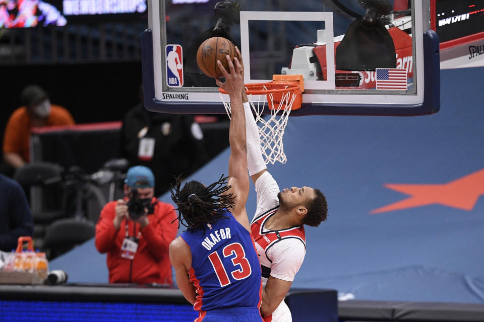 Detroit Pistons center Jahlil Okafor, left, is blocked by Washington Wizards center Daniel Gafford, right, during the first half of an NBA basketball game, Saturday, April 17, 2021, in Washington. (AP Photo/Nick Wass)