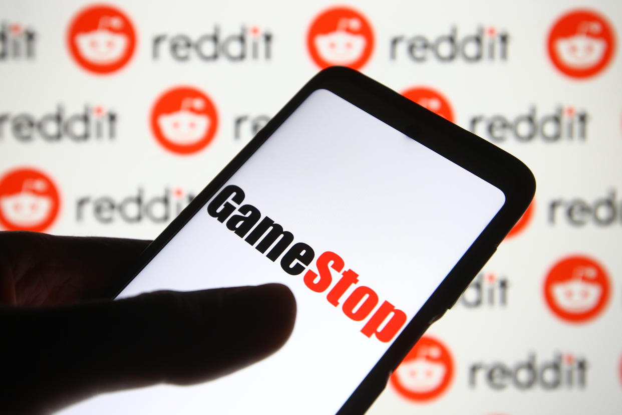 UKRAINE - 2021/02/05: In this photo illustration a GameStop logo is seen on a mobile phone screen in front of Reddit logo. (Photo Illustration by Pavlo Gonchar/SOPA Images/LightRocket via Getty Images)