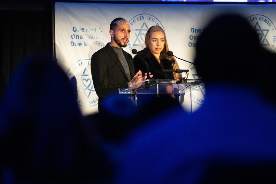 Feb 22, 2024; Teaneck, New Jersey, USA; Roi Assaraf and his wife Yona speak during an event at Congregation Keter Torah about surviving the deadly attack at the Tribe of Nova music festival.