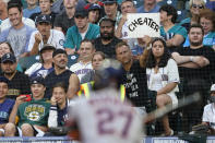 A fan holds up a sign that reads "cheater" as Houston Astros' Jose Altuve bats during the second inning of the team's baseball game against the Seattle Mariners, Tuesday, July 27, 2021, in Seattle. (AP Photo/Ted S. Warren)