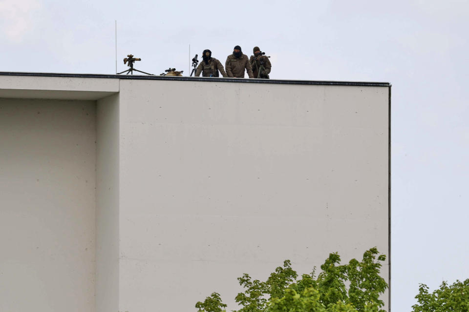Snipers are seen on the roof of the Chancellor's Office during the visit of Ukrainian President Volodymyr Zelenskyy, in Berlin, Sunday, May 14, 2023. Zelenskyy arrived in Berlin early Sunday for talks with German leaders about further arms deliveries to help his country fend off the Russian invasion and rebuild what’s been destroyed by more than a year of devastating conflict. (J'rg Carstensen/dpa via AP)