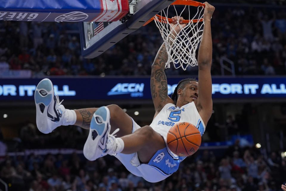 North Carolina forward Armando Bacot (5) hanging from the basket after scoring against Pittsburgh during the first half of an NCAA college basketball game in the semifinal round of the Atlantic Coast Conference tournament Friday, March 15, 2024, in Washington. (AP Photo/Susan Walsh)