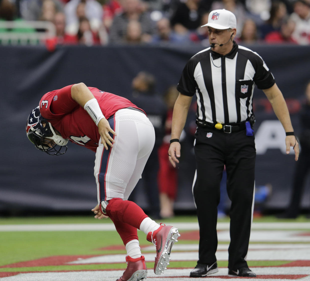 HOUSTON, TX - DECEMBER 10: Referee John Hussey #35 watches Tom Savage #3 of the Houston Texans get off the turf after a hit in the second quarter against the San Francisco 49ers at NRG Stadium on December 10, 2017 in Houston, Texas. (Photo by Tim Warner/Getty Images)