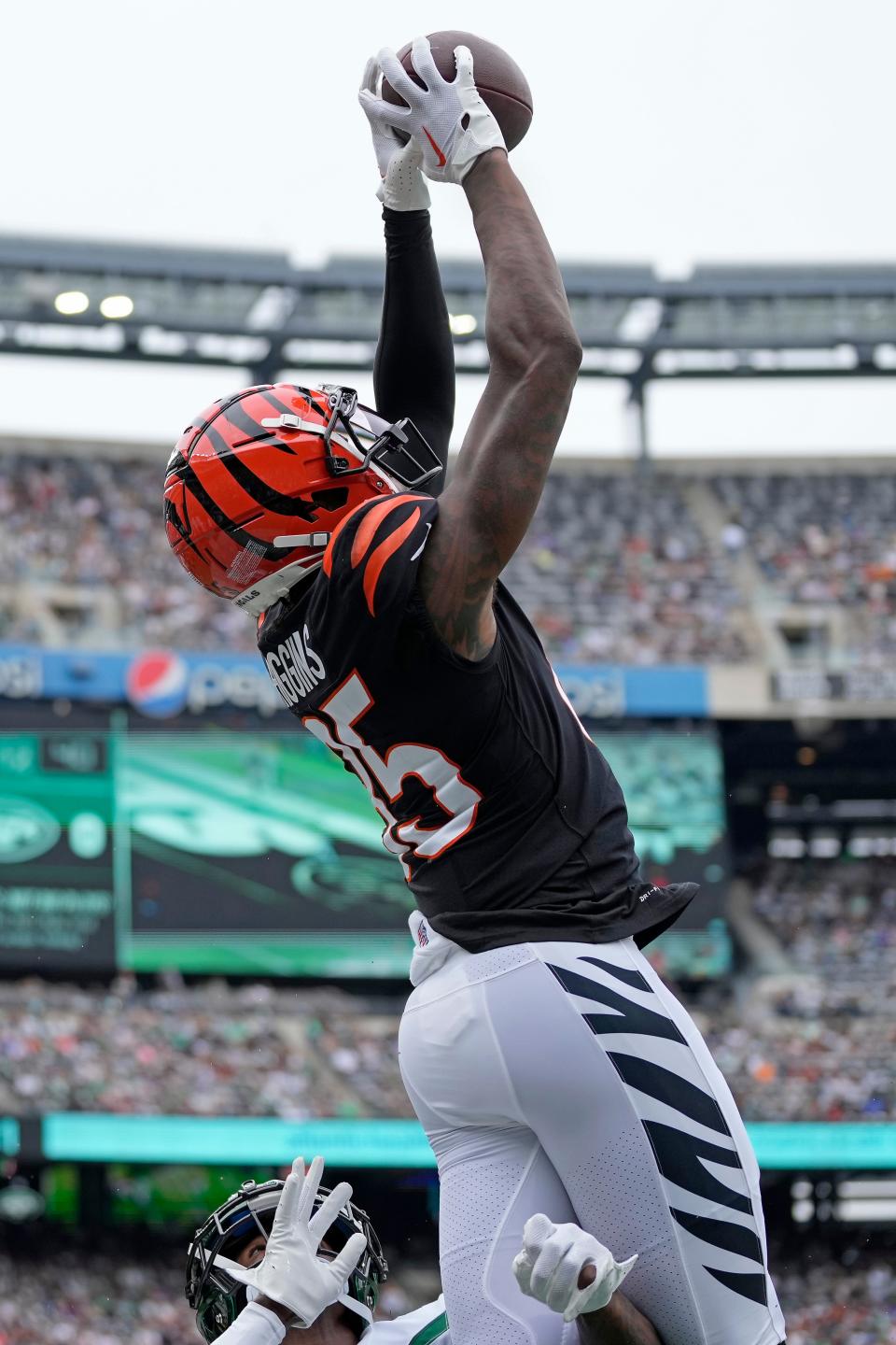 Cincinnati Bengals wide receiver Tee Higgins (85) leaps for a catch over New York Jets cornerback D.J. Reed (4) back lands out of bounds, confirmed by official review, in the first quarter of the NFL Week 3 game between the New York Jets and the Cincinnati Bengals at MetLife Stadium in East Rutherford, N.J., on Sunday, Sept. 25, 2022. Higgins had a big role in the Bengals' explosive offense in New York.