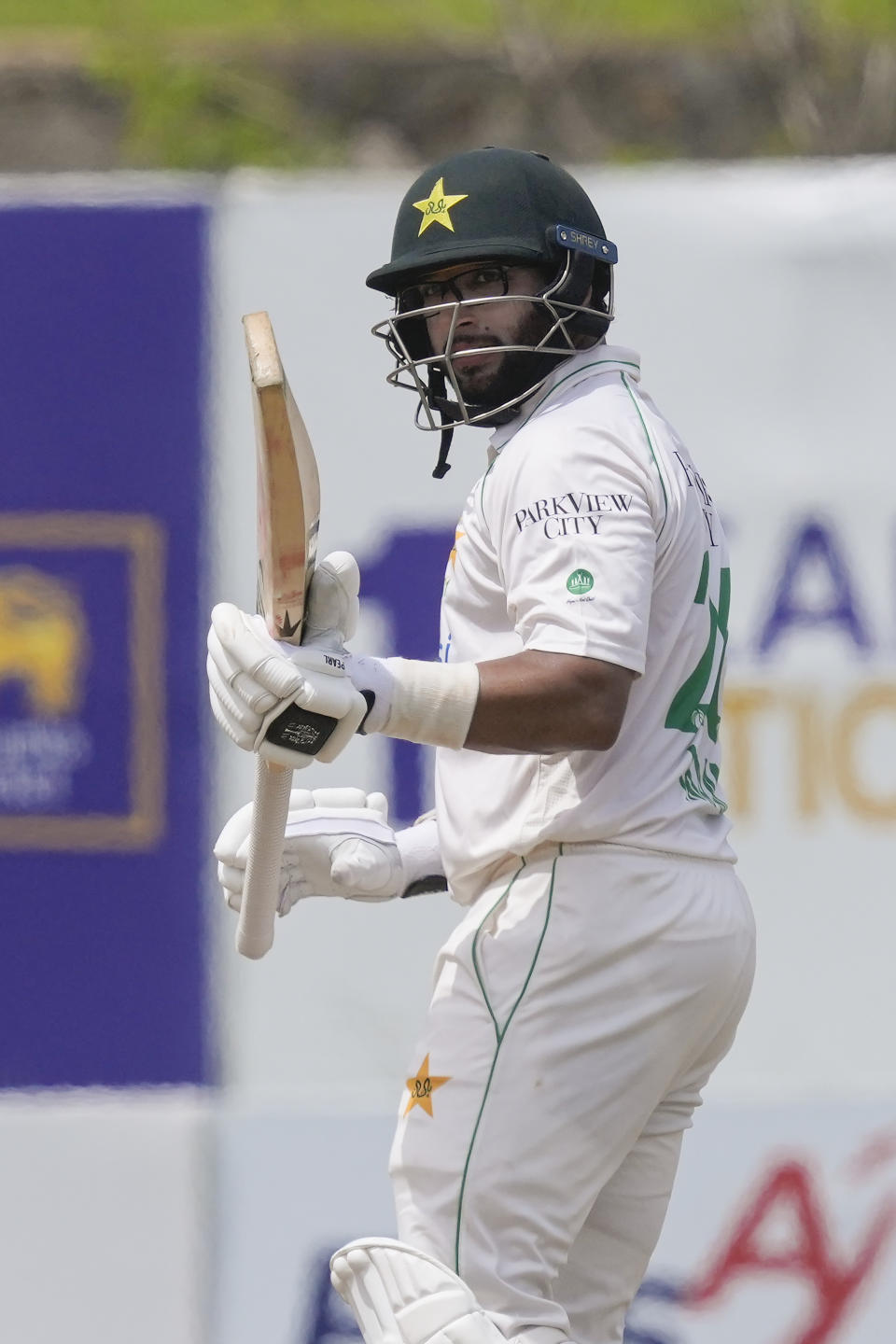 Pakistan's Imam-ul-Haq celebrates scoring a half century during the fifth day of the first cricket test match between Sri Lanka and Pakistan in Galle, Sri Lanka on Thursday, July 20, 2023. (AP Photo/Eranga Jayawardena)