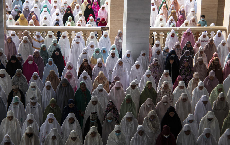 Indonesian Muslims perform Eid al-Adha prayers at a mosque in Lhokseumawe, Aceh province, Indonesia Tuesday, July 20, 2021. Muslims across Indonesia marked a grim Eid al-Adha festival for a second year Tuesday as the country struggles to cope with a devastating new wave of coronavirus cases and the government has banned large gatherings and toughened travel restrictions. (AP Photo/Zik Maulana)