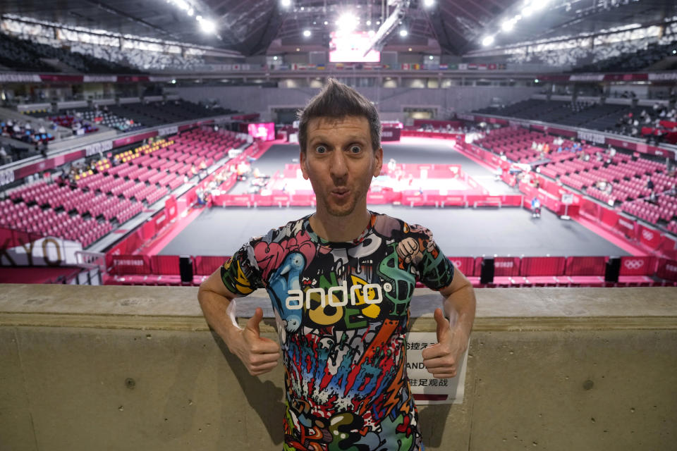 Adam Bobrow, lead commentator for the International Table Tennis Federation, poses for a photograph during the table tennis men's team semifinal between Germany and Japan at the 2020 Summer Olympics, Wednesday, Aug. 4, 2021, in Tokyo. Bobrow, the Voice of Table Tennis, possesses an arsenal of tricky spin shots, captured on YouTube and watched by millions, that can leave even good opponents gape-mouthed and then, as the wildness of what they’ve seen sinks in, delighted. What he really likes, though, is to travel the world as a sort of ambassador for the sport. (AP Photo/Kin Cheung)