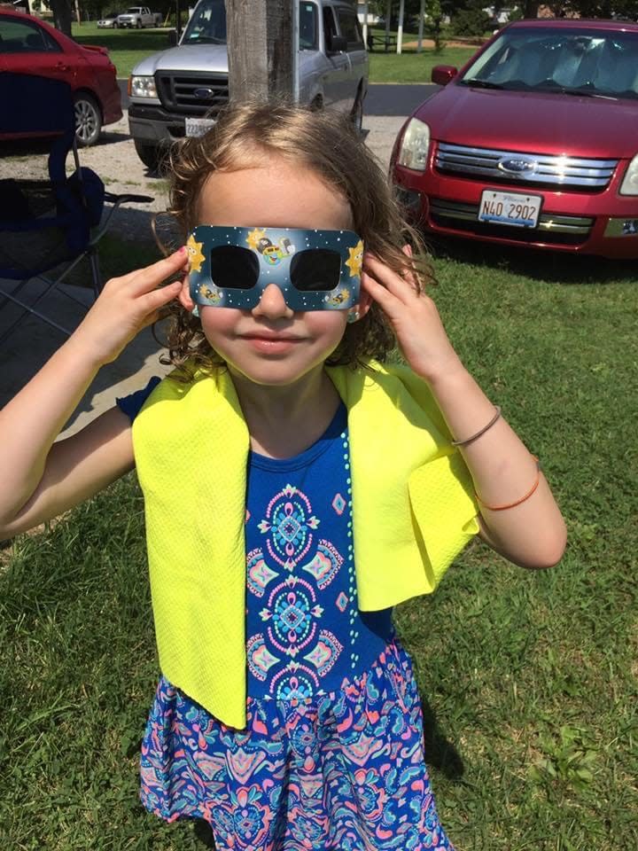 Vivien Darling of Springfield, then 5, models a pair of solar eclipse glasses on August 21, 2017. Darling and her family viewed the total eclipse in a community park in Ava, Illinois, and are returning to southern Illinois for Monday's total eclipse.